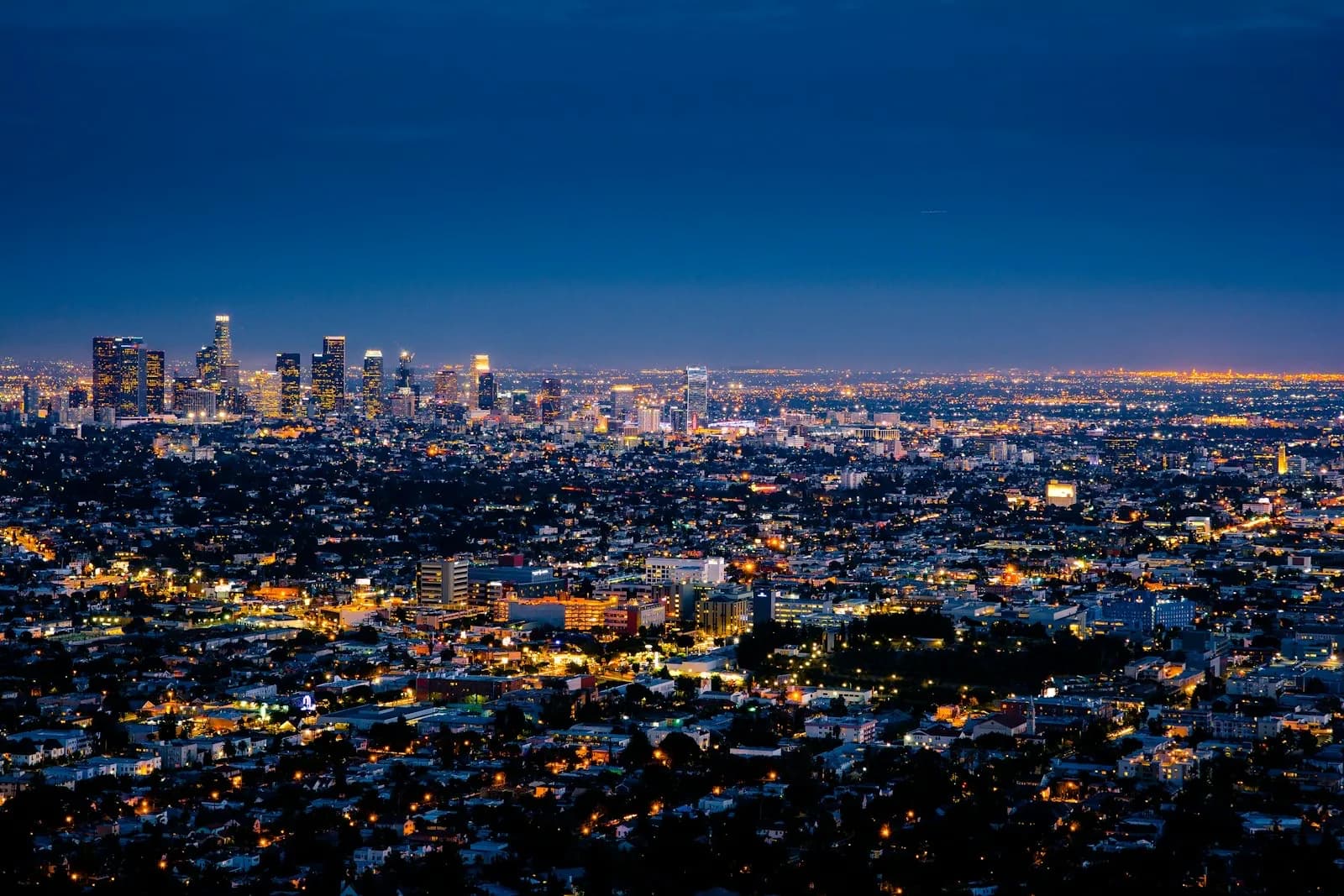 Dense city skyline lit at dusk