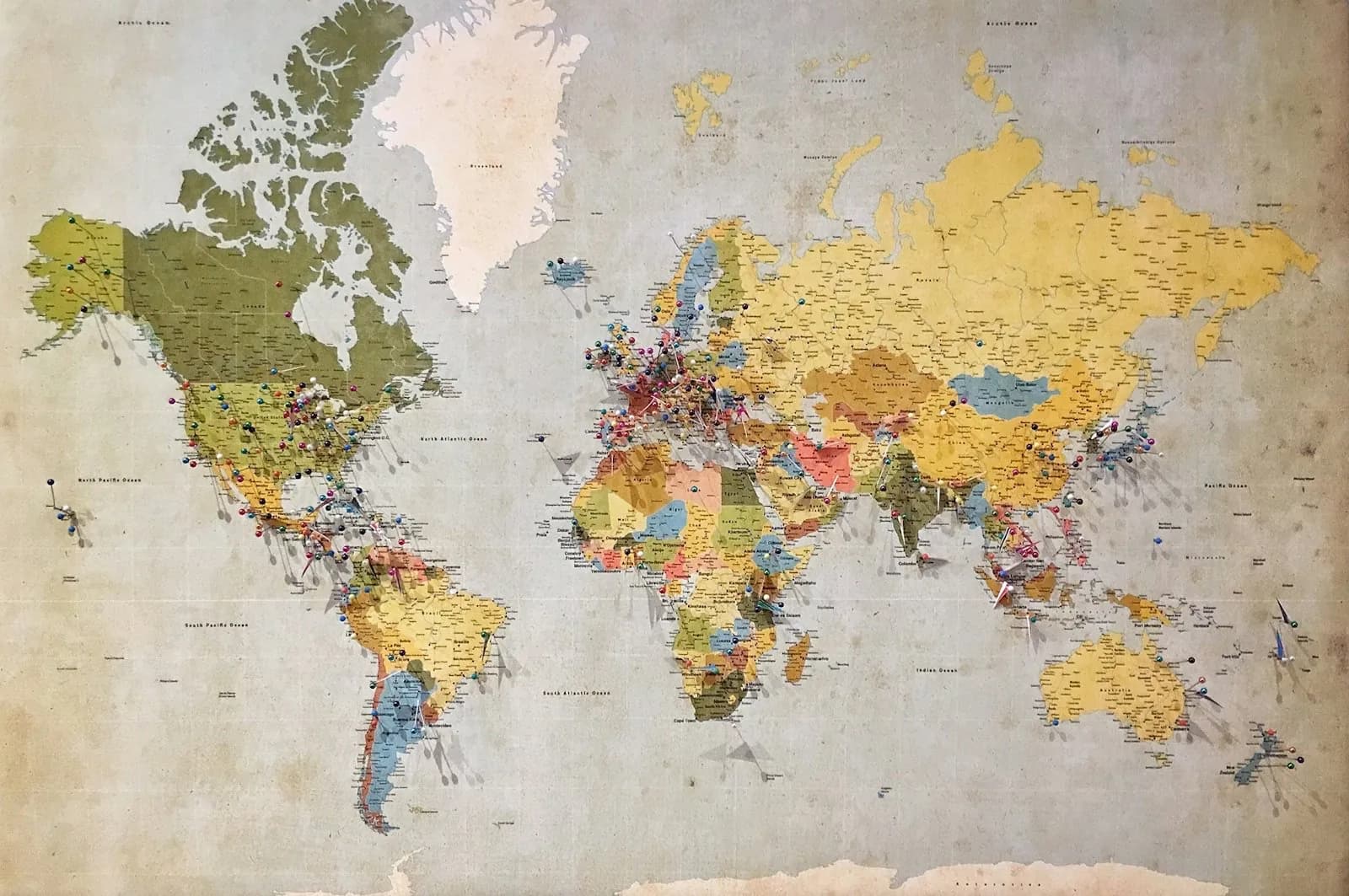A political world map marked with location pins across continents